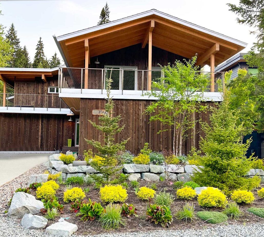 Entryway and driveway of the Fitzsimmons house, featuring clean lines, wood textures, and low-impact landscaping.