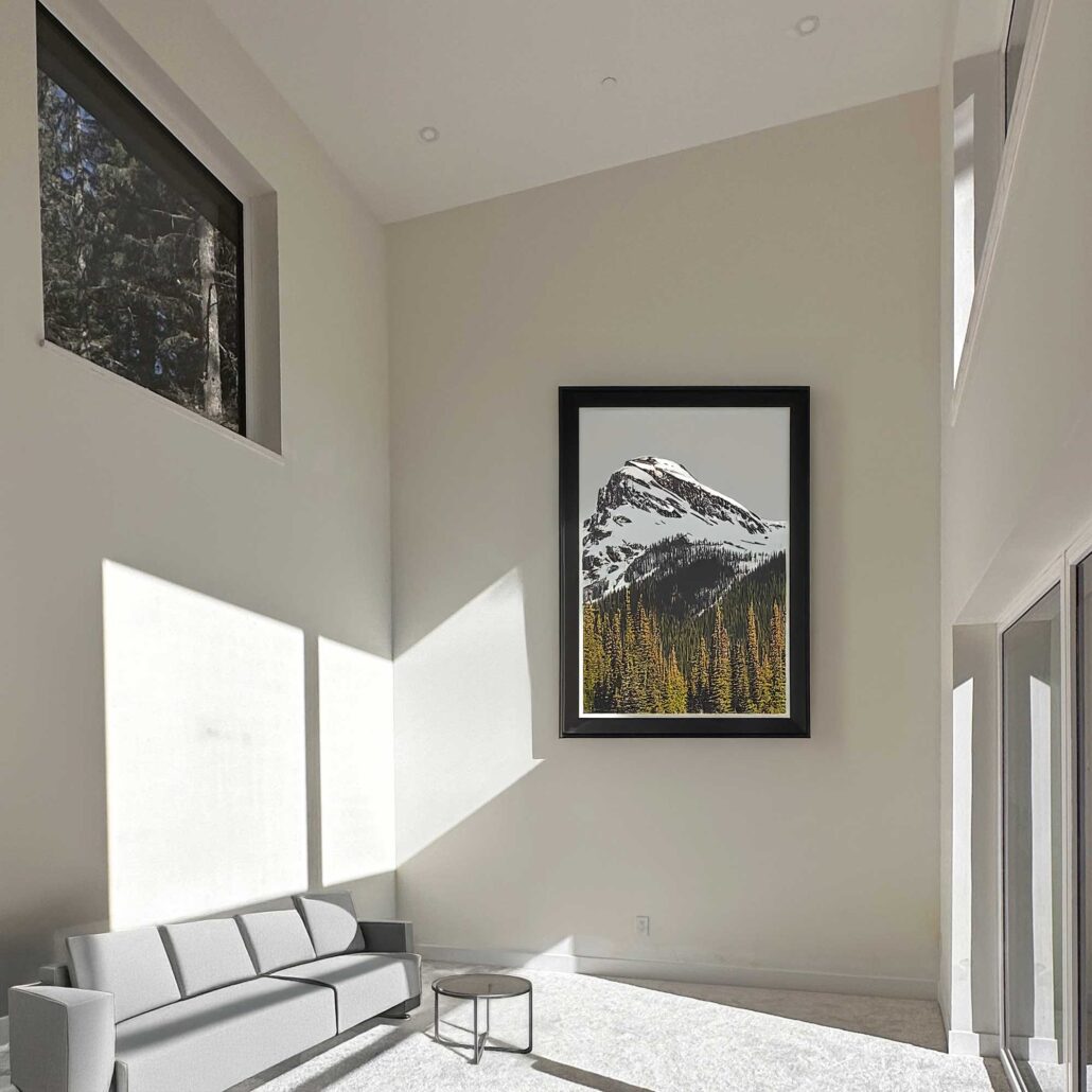 Open living area with large sliding doors framing views of Whistler Blackcomb and the double-sided fireplace.
