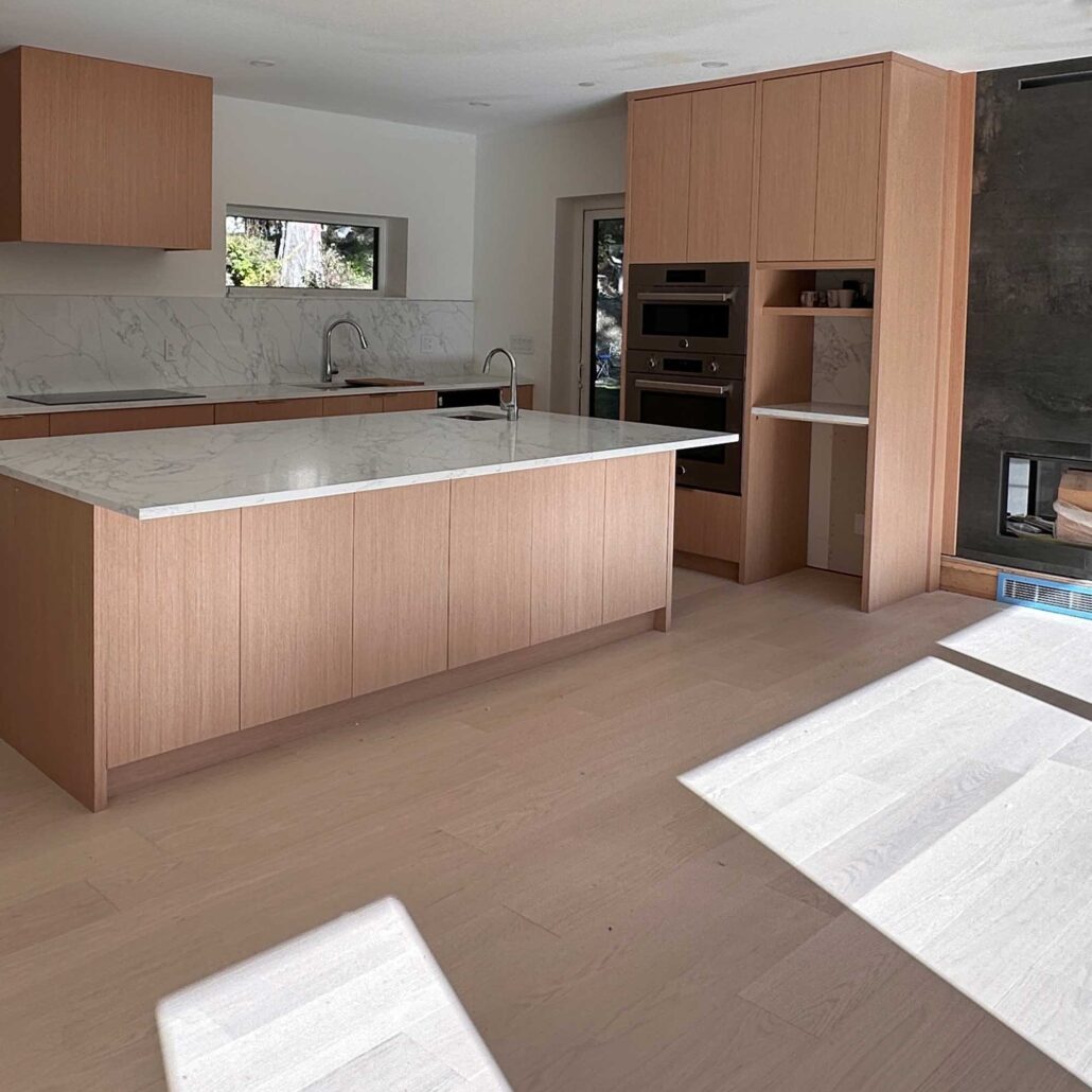 Sunlight filling a minimalist kitchen with clean lines and natural wood tones.