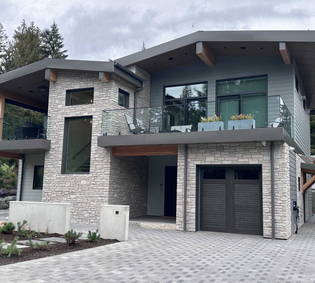 Driveway and façade of the expanded Camino Drive residence with landscaped entry and modern architecture.