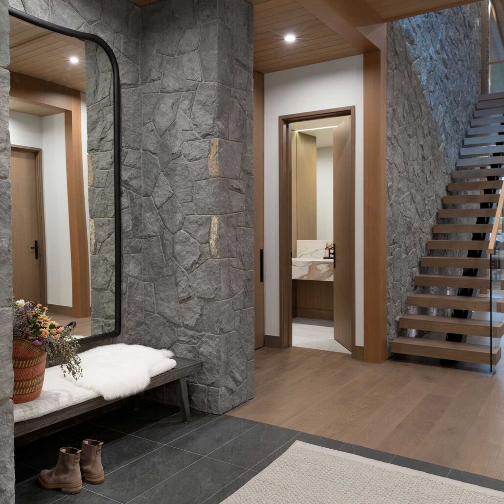 Interior stairway featuring stone accents and natural wood