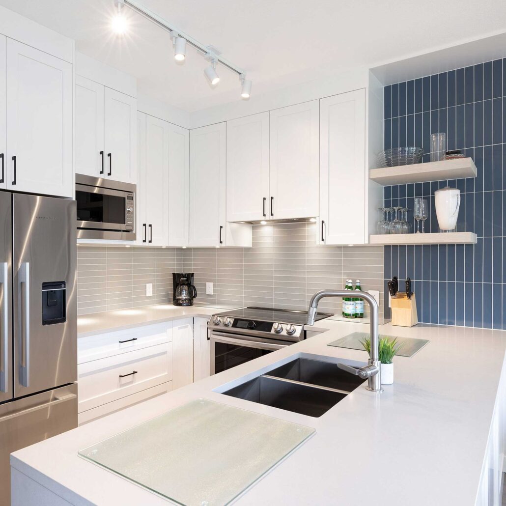 Modern appliance wall with integrated white cabinetry in bright Whistler kitchen