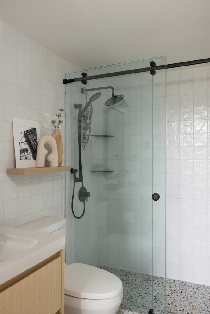 Bathroom with glass shower, wall tile, and modern fixtures